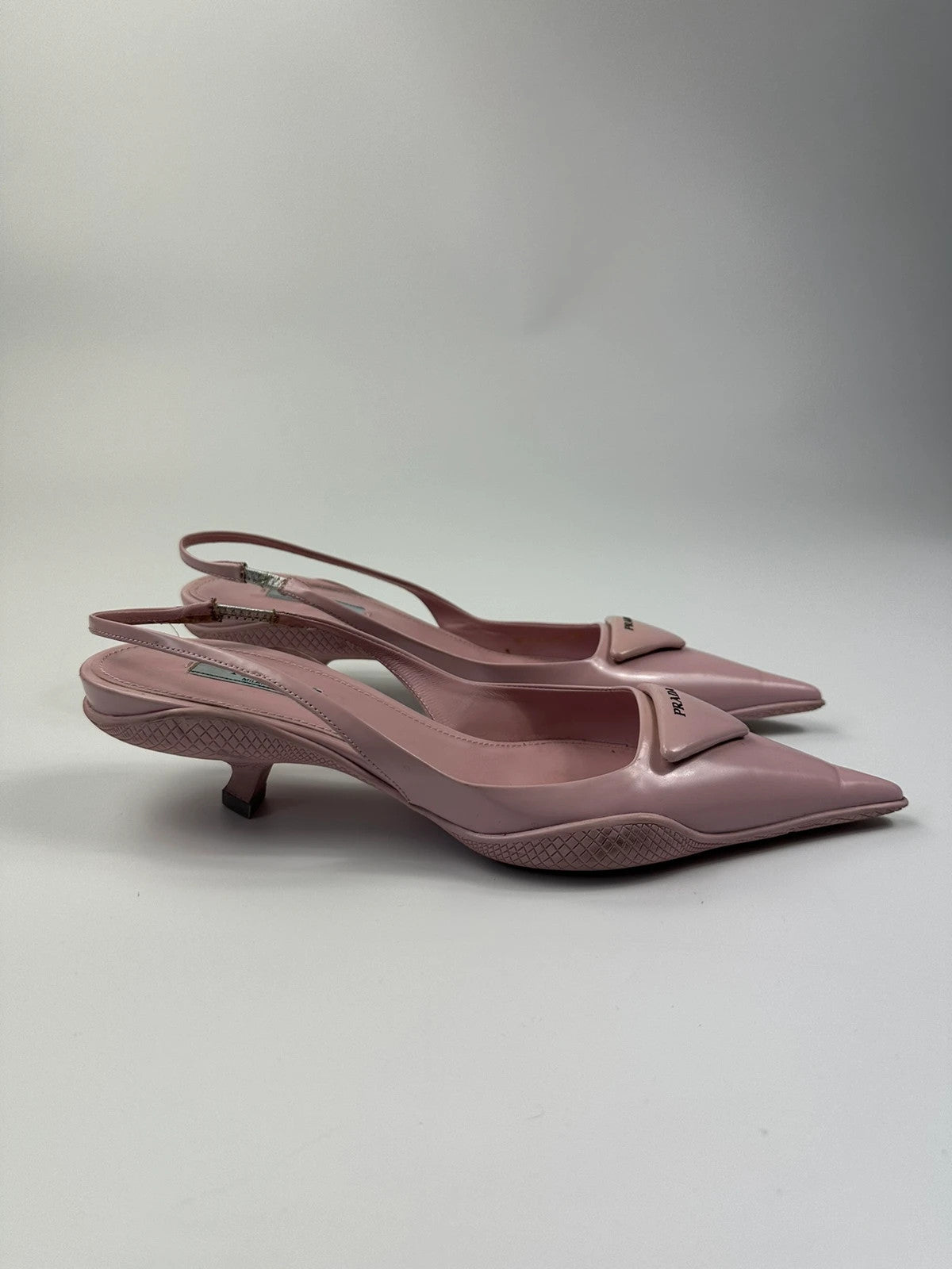 Prada pink leather heels with pointed toe and logo detail from SS2021 collection.