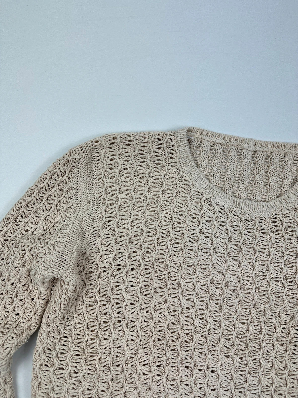 Prada beige silk knit sweater with intricate openwork design and subtle sheen.