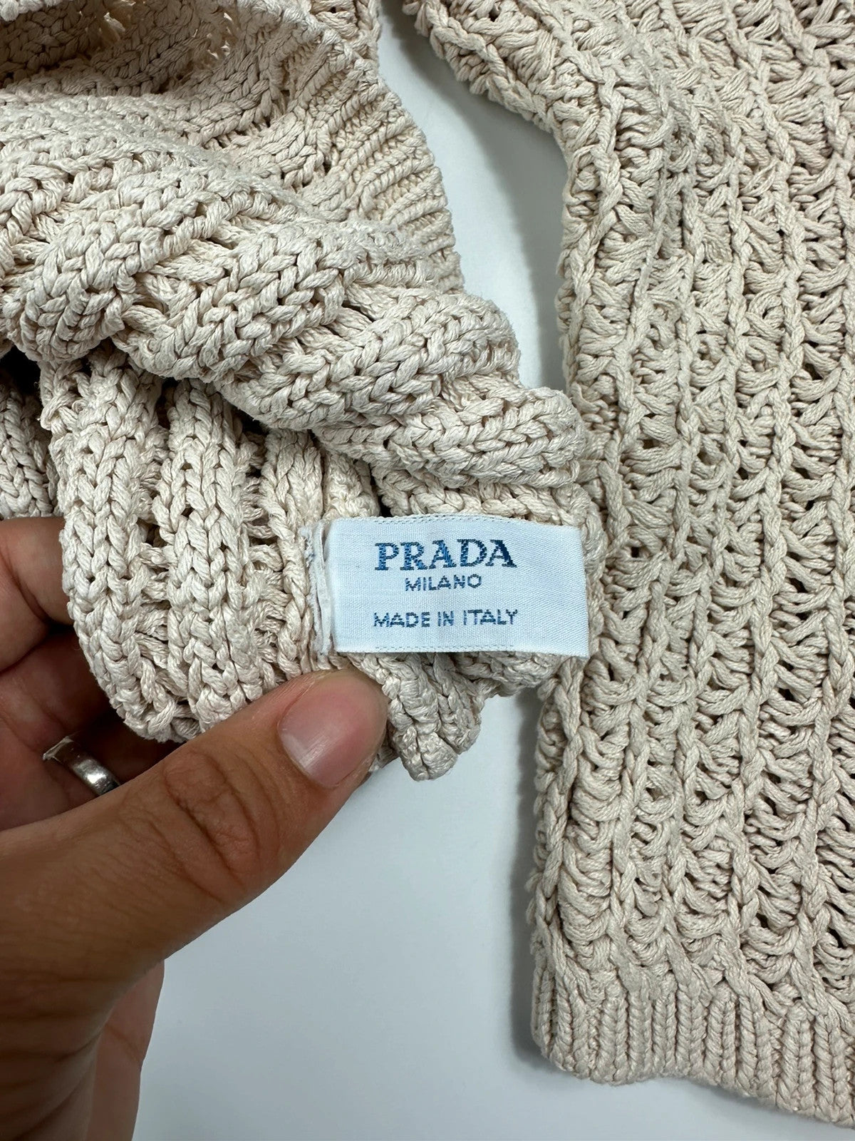 Prada beige silk knit sweater with intricate openwork design and subtle sheen.