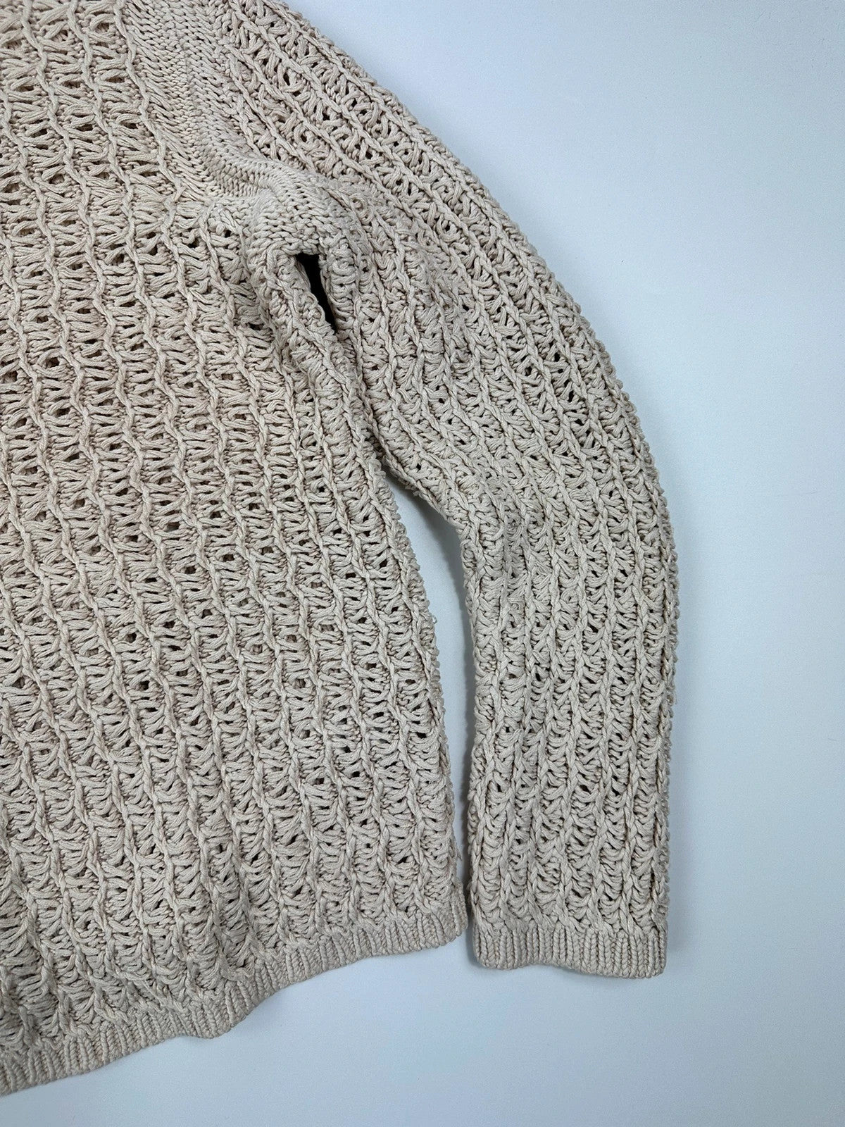 Prada beige silk knit sweater with intricate openwork design and subtle sheen.