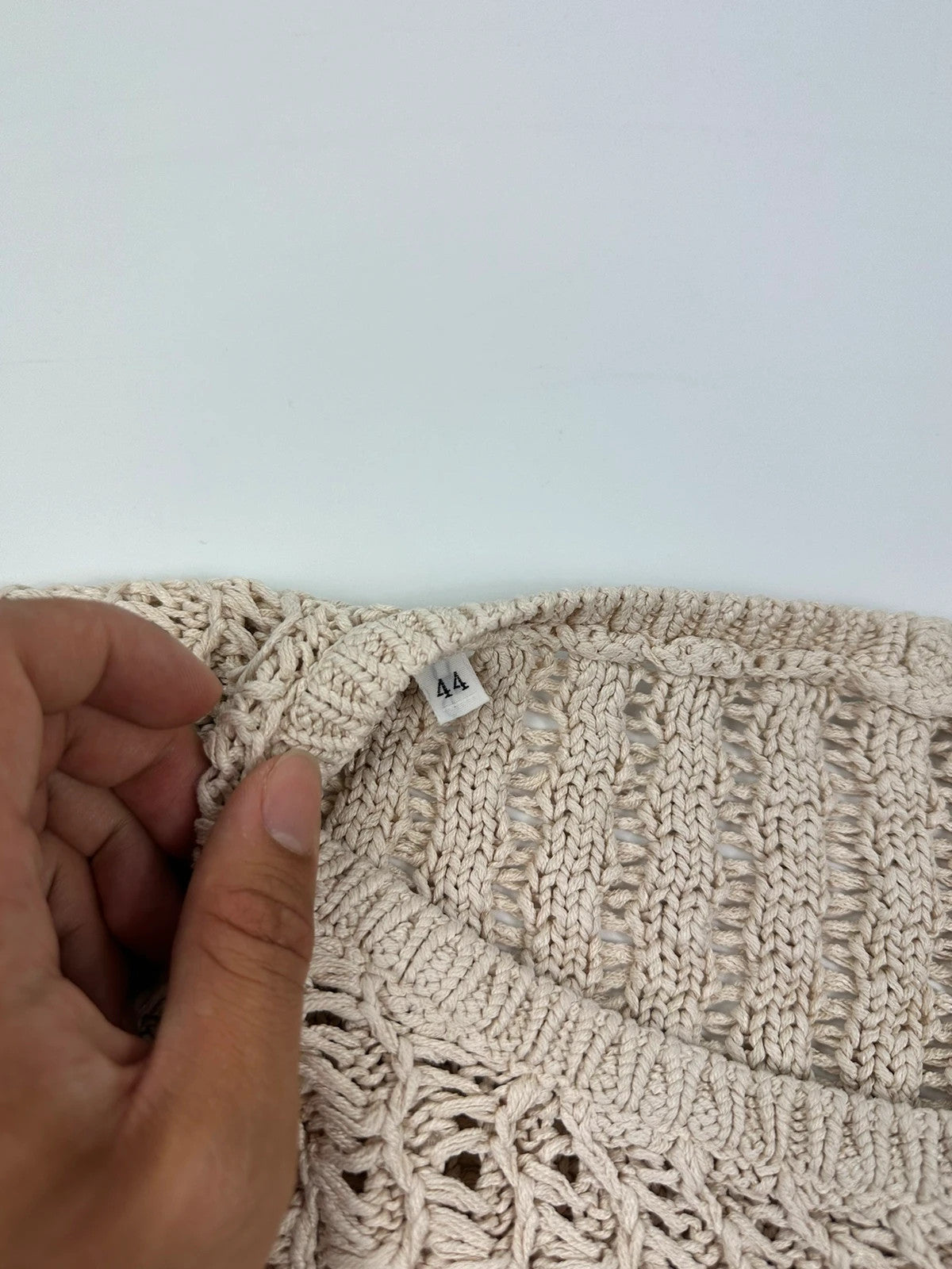 Prada beige silk knit sweater with intricate openwork design and subtle sheen.