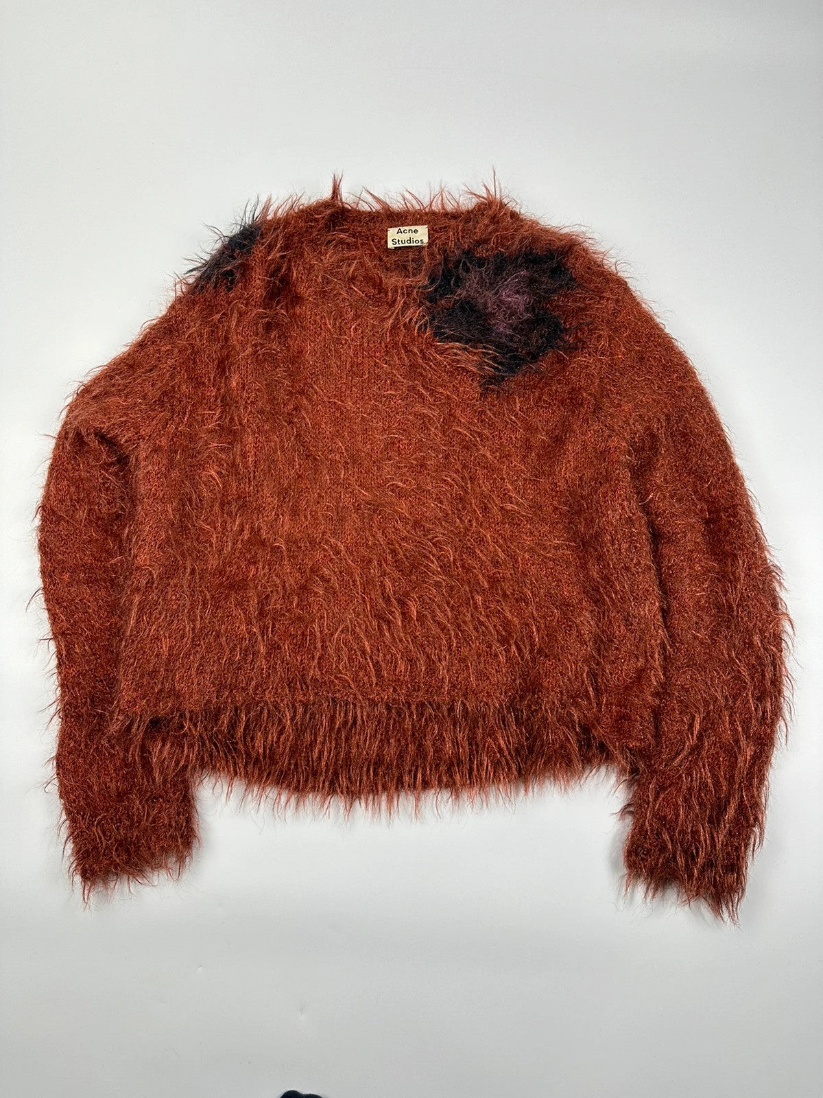 Acne Studios oversized cropped sweater in red and orange hairy knit texture.