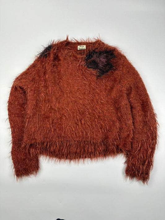 Acne Studios oversized cropped sweater in red and orange hairy knit texture.