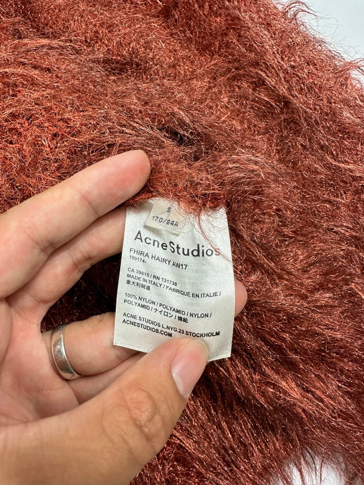 Acne Studios oversized cropped sweater in red and orange hairy knit texture.
