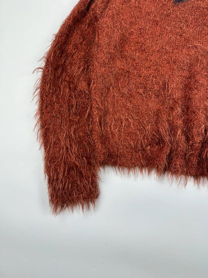 Acne Studios oversized cropped sweater in red and orange hairy knit texture.