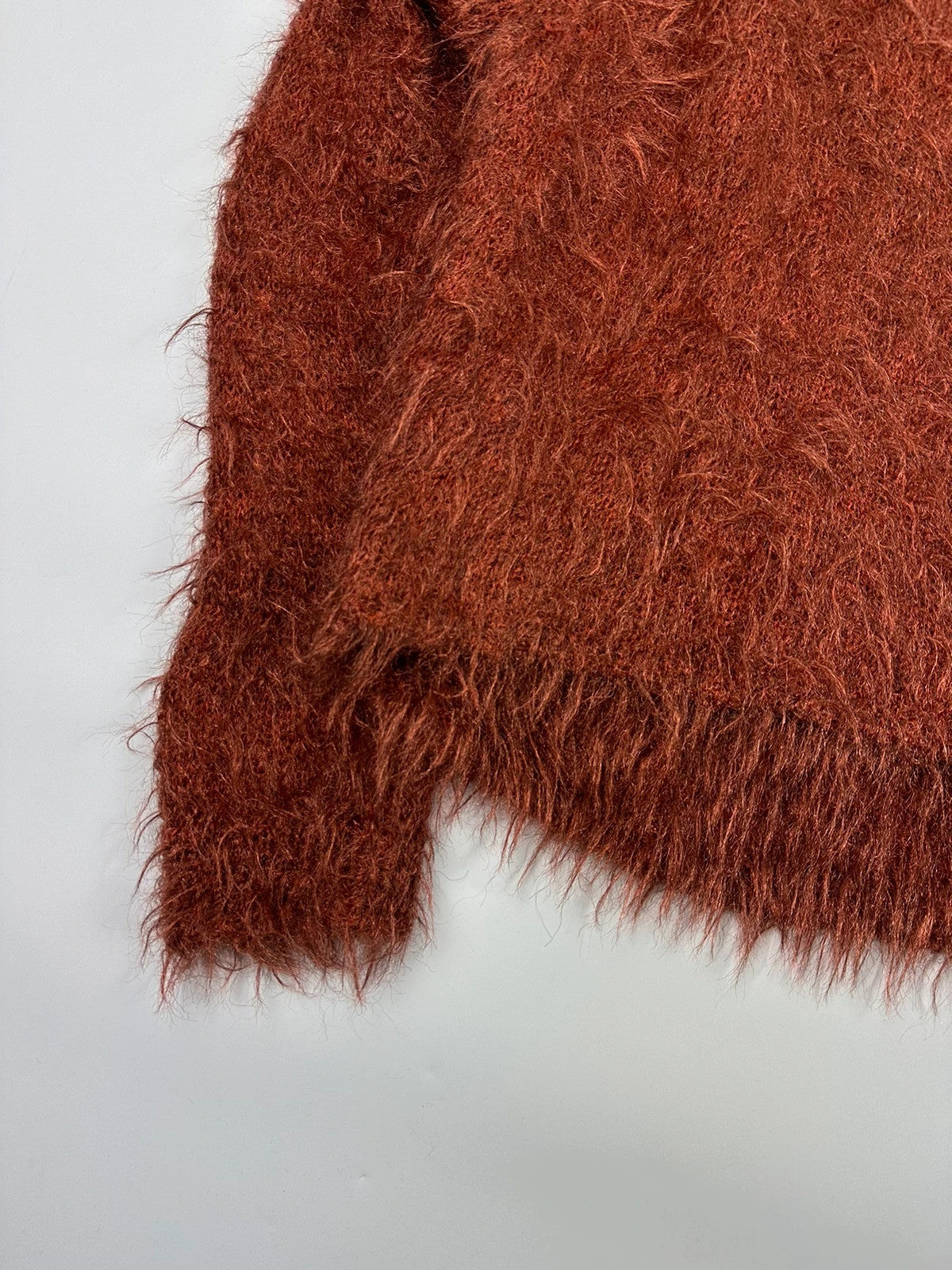 Acne Studios oversized cropped sweater in red and orange hairy knit texture.