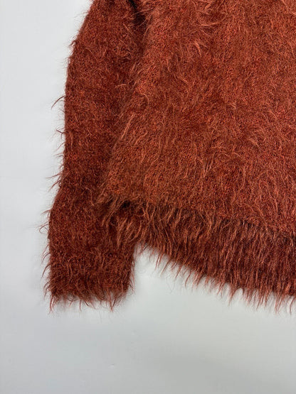 Acne Studios oversized cropped sweater in red and orange hairy knit texture.