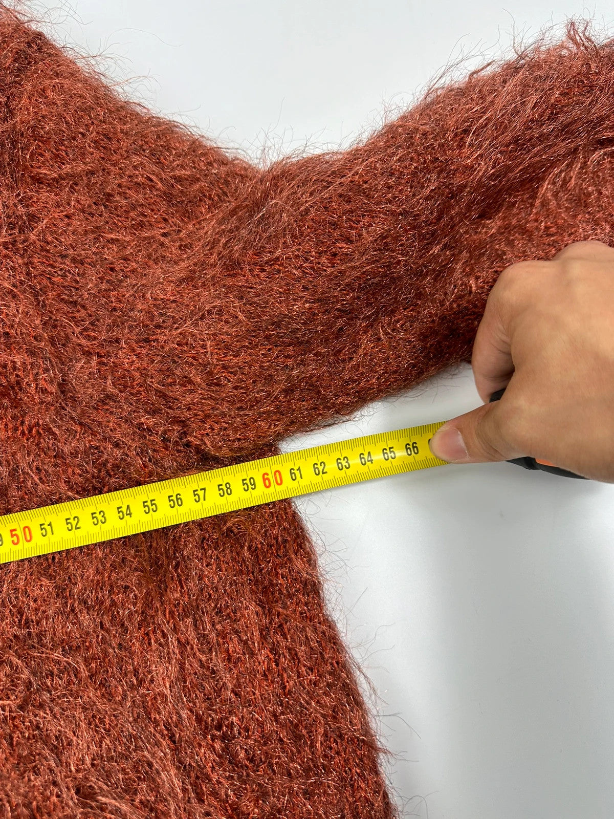 Acne Studios oversized cropped sweater in red and orange hairy knit texture.