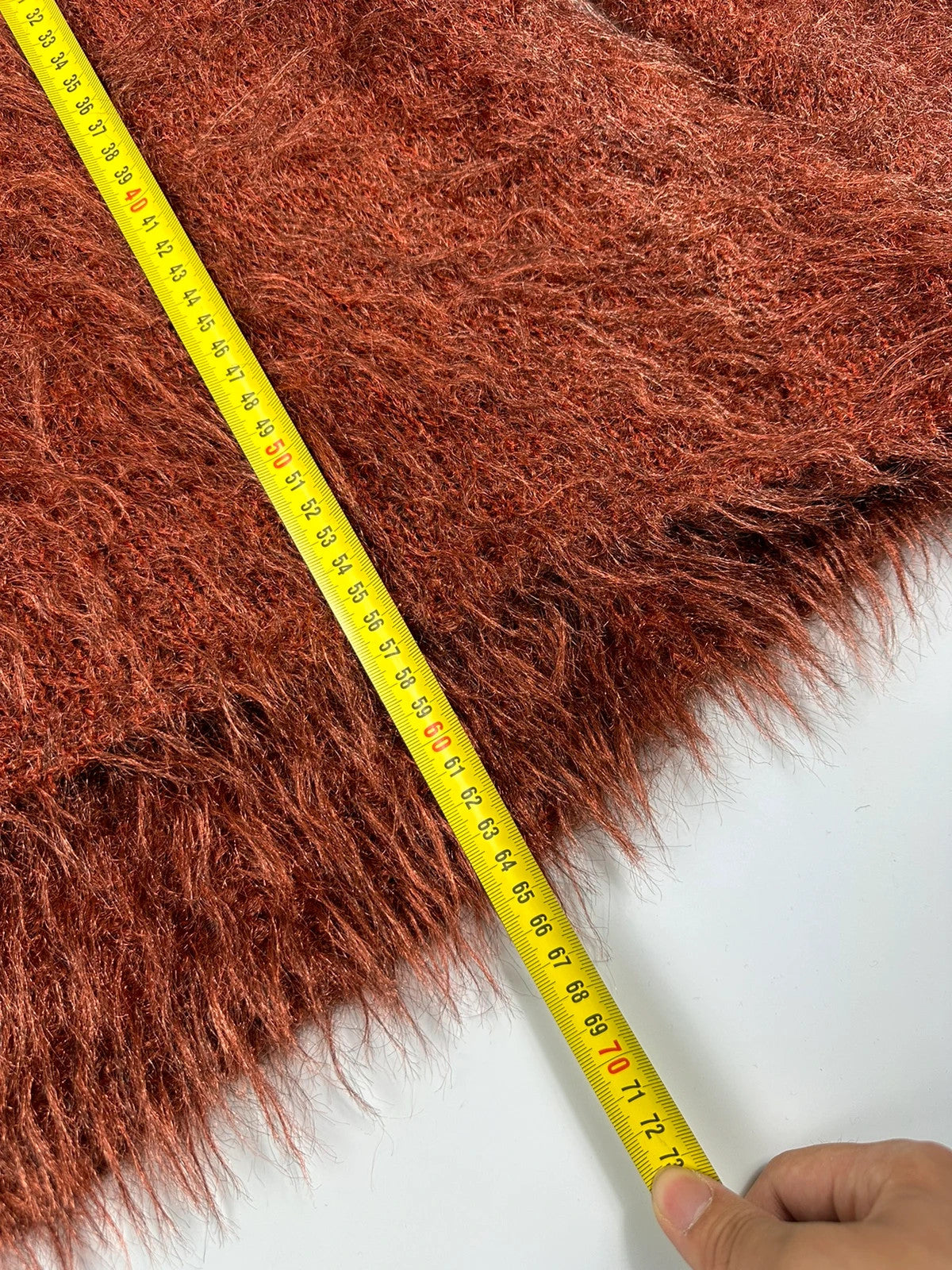 Acne Studios oversized cropped sweater in red and orange hairy knit texture.