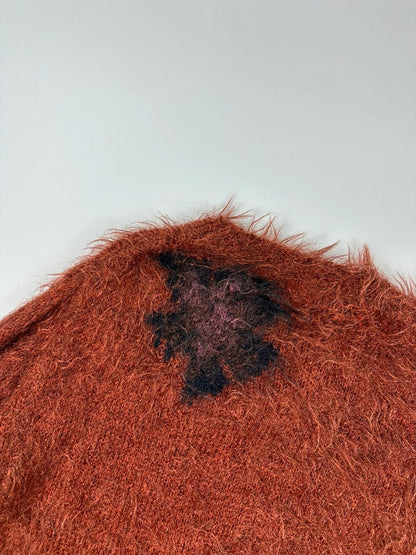 Acne Studios oversized cropped sweater in red and orange hairy knit texture.