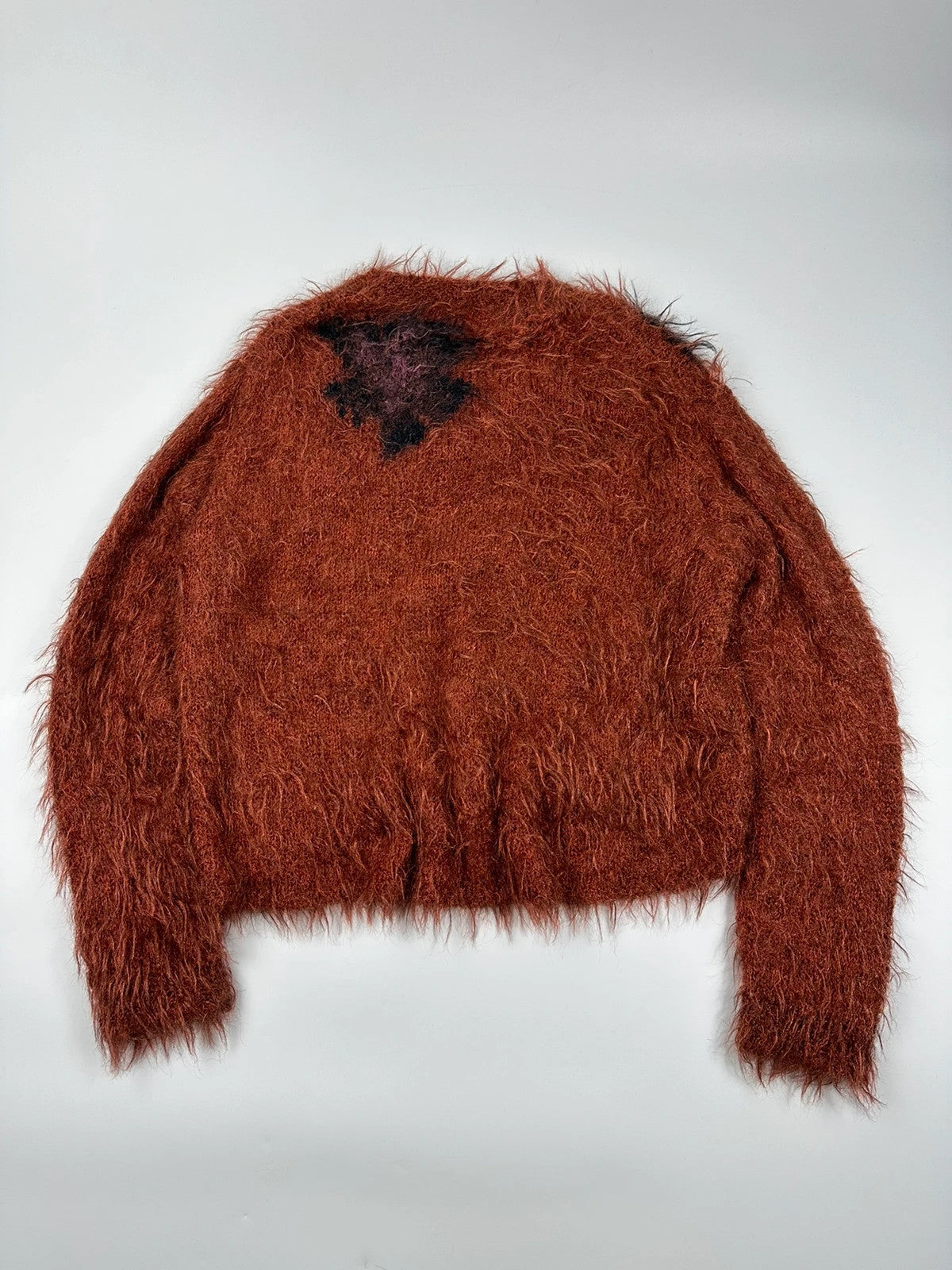 Acne Studios oversized cropped sweater in red and orange hairy knit texture.
