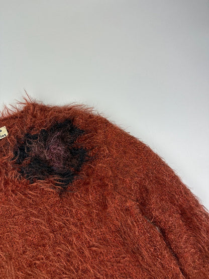 Acne Studios oversized cropped sweater in red and orange hairy knit texture.