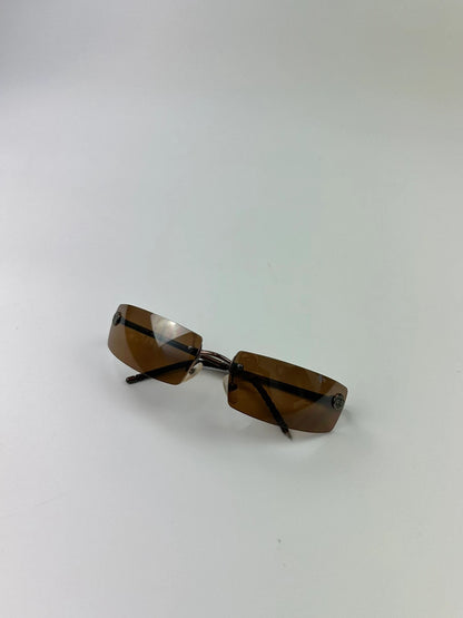 Chanel brown and orange rimless sunglasses with double CC logo detail.