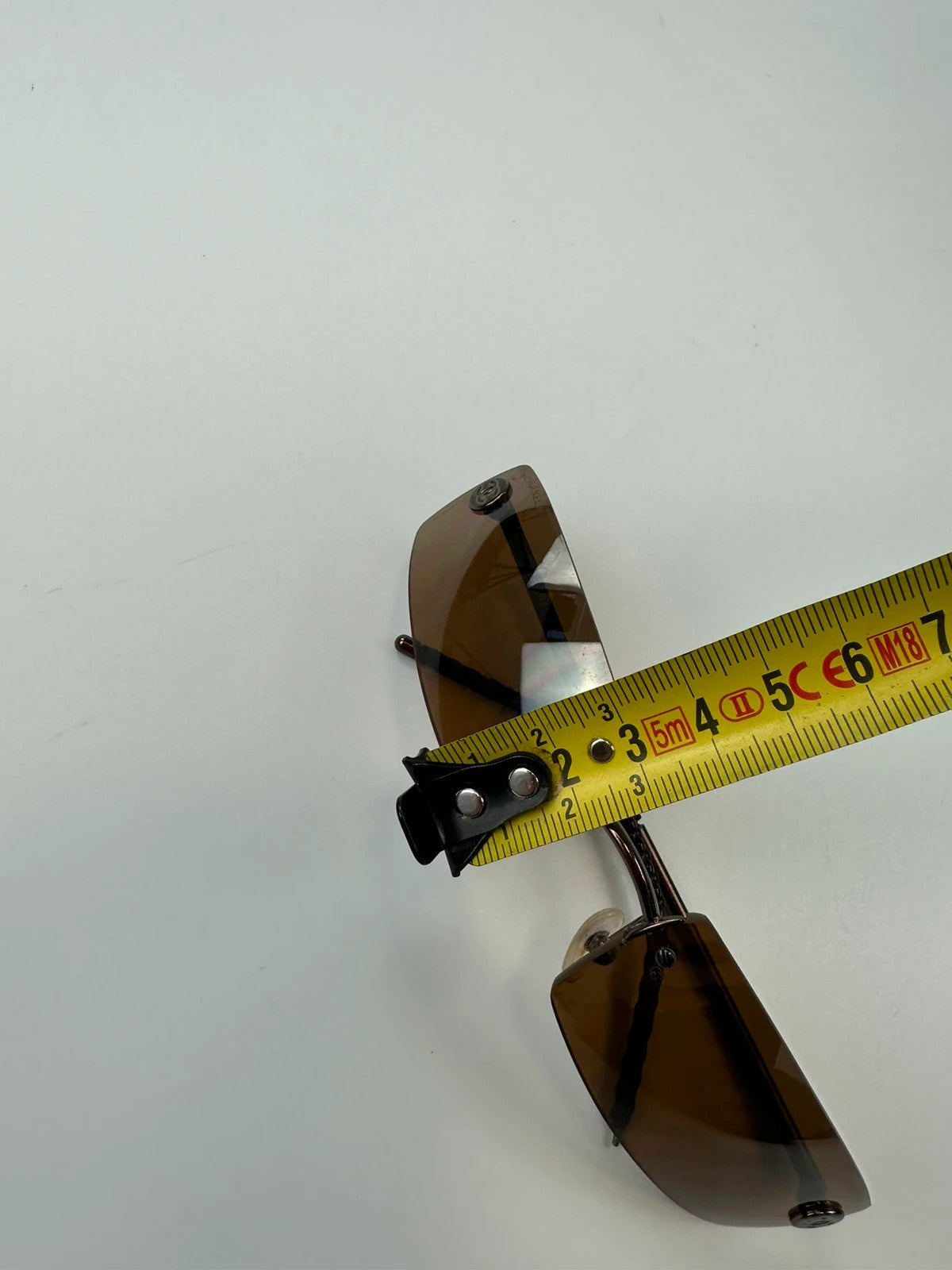 Chanel brown and orange rimless sunglasses with double CC logo detail.