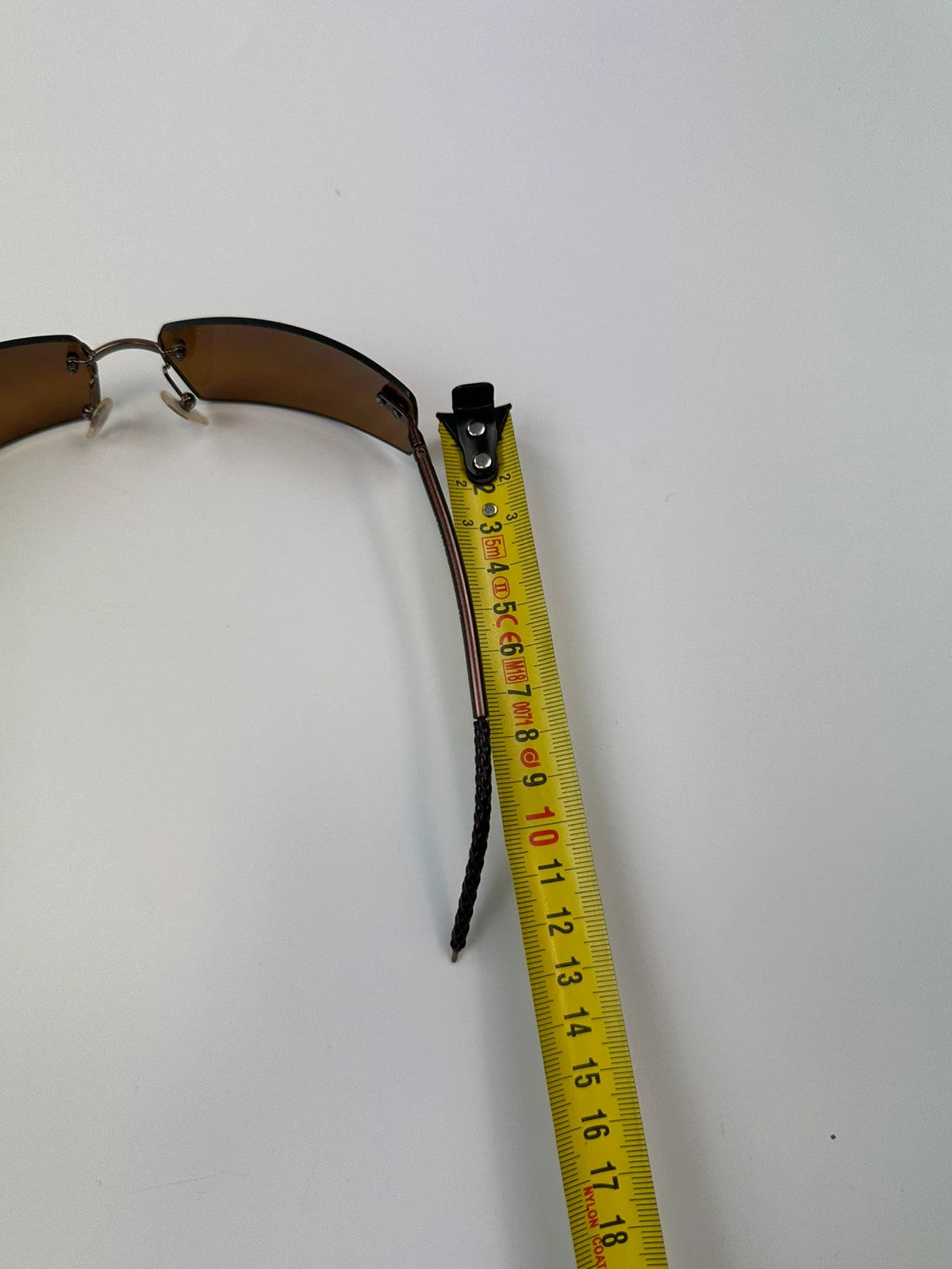 Chanel brown and orange rimless sunglasses with double CC logo detail.