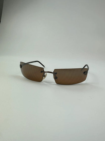 Chanel brown and orange rimless sunglasses with double CC logo detail.