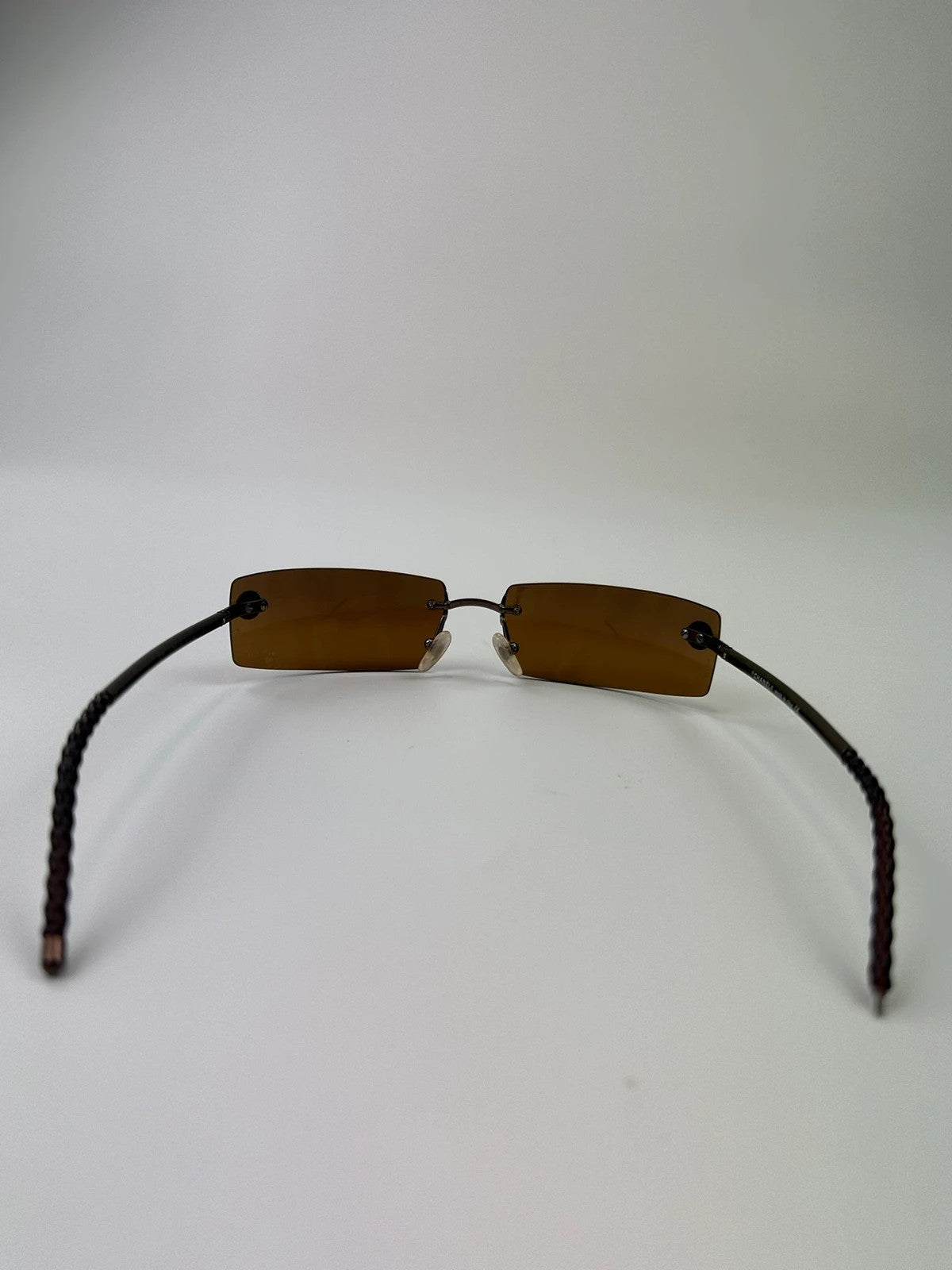 Chanel brown and orange rimless sunglasses with double CC logo detail.