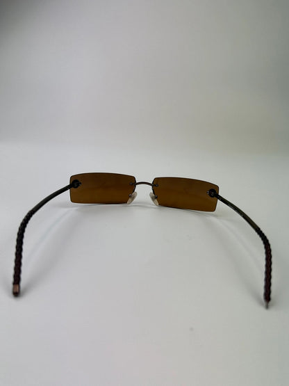 Chanel brown and orange rimless sunglasses with double CC logo detail.