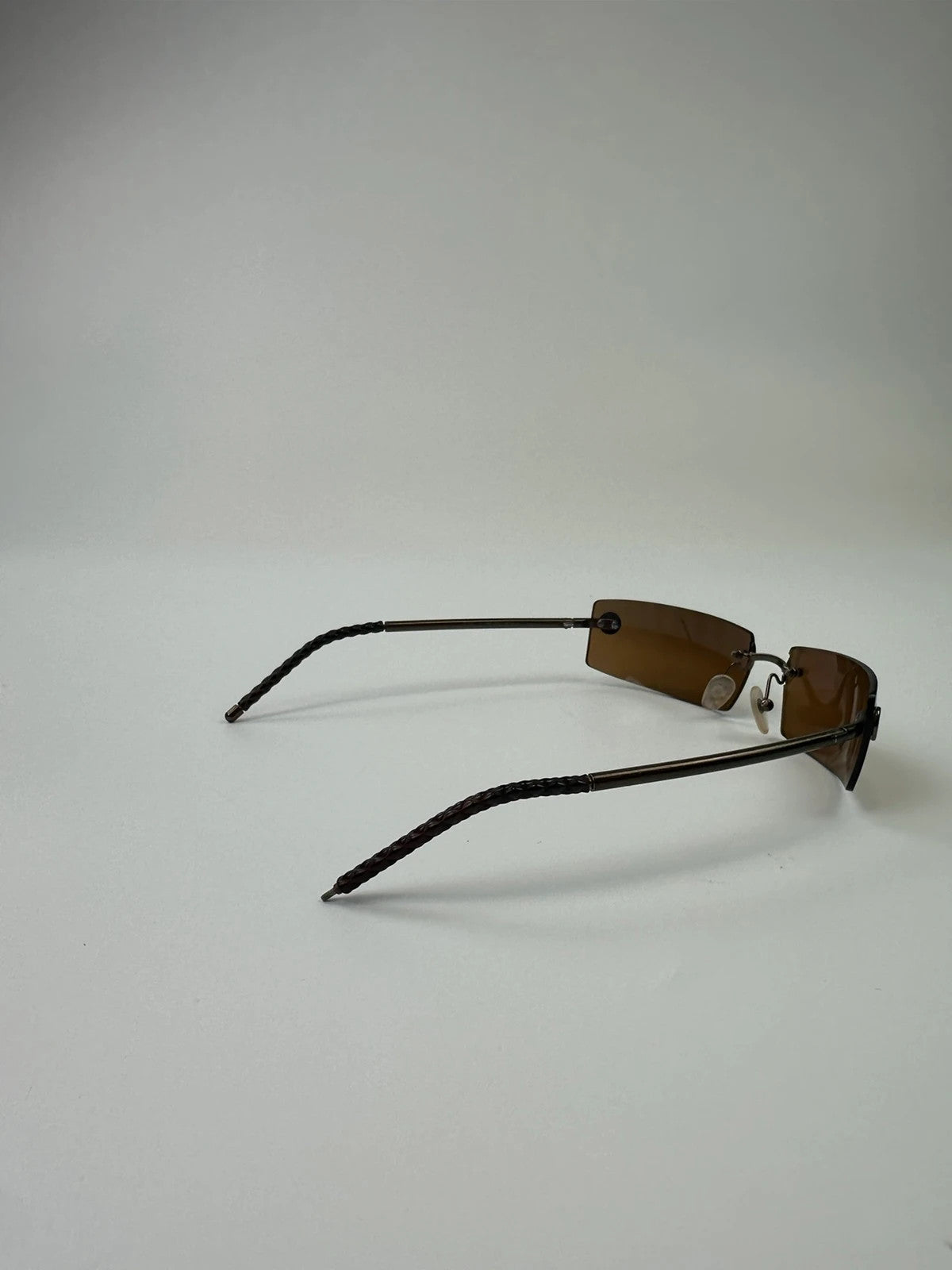 Chanel brown and orange rimless sunglasses with double CC logo detail.