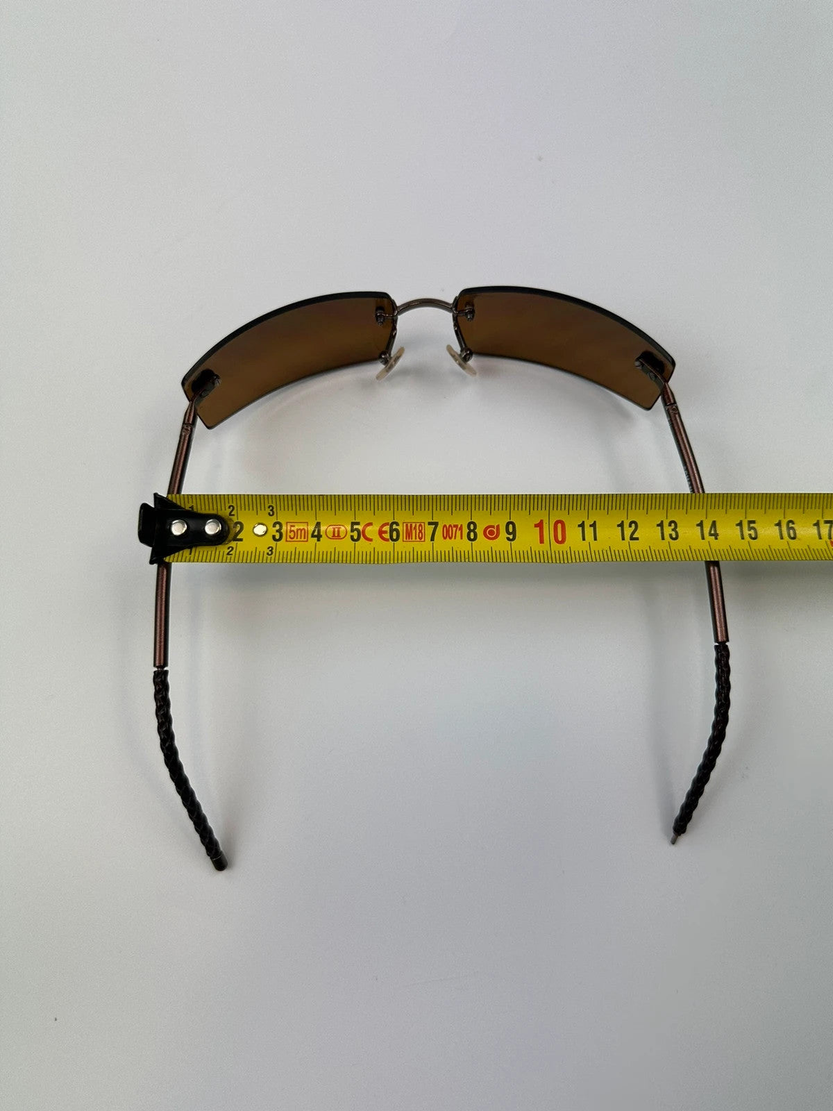 Chanel brown and orange rimless sunglasses with double CC logo detail.