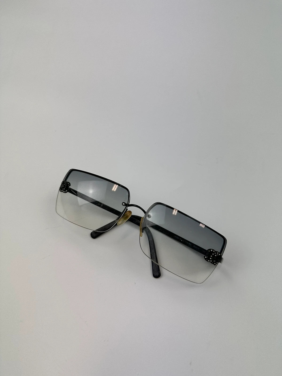 Chanel black and blue rimless sunglasses with double CC logo and strass details.