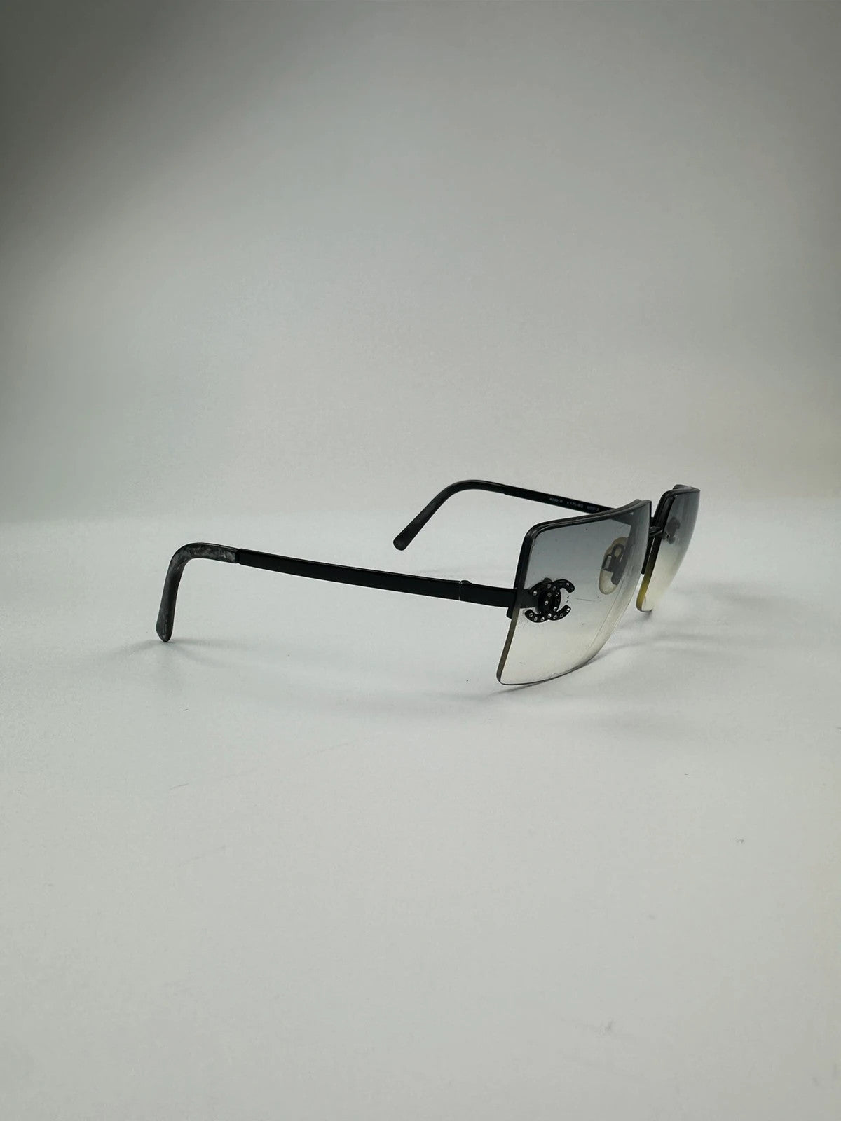 Chanel black and blue rimless sunglasses with double CC logo and strass details.