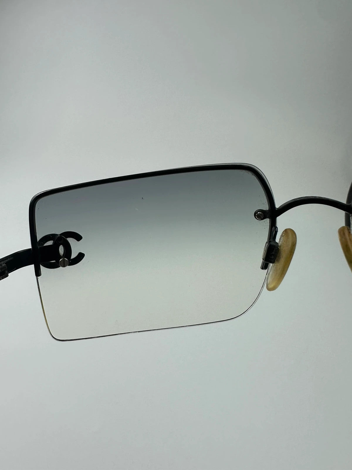 Chanel black and blue rimless sunglasses with double CC logo and strass details.