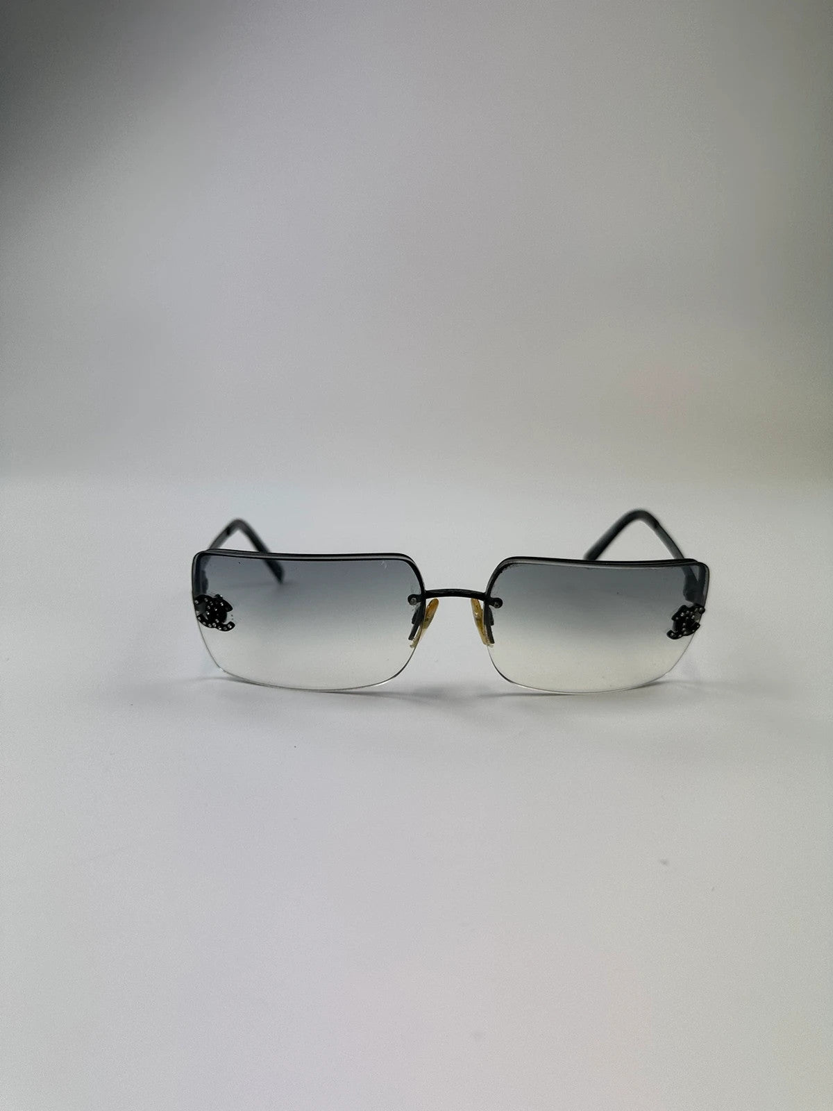 Chanel black and blue rimless sunglasses with double CC logo and strass details.