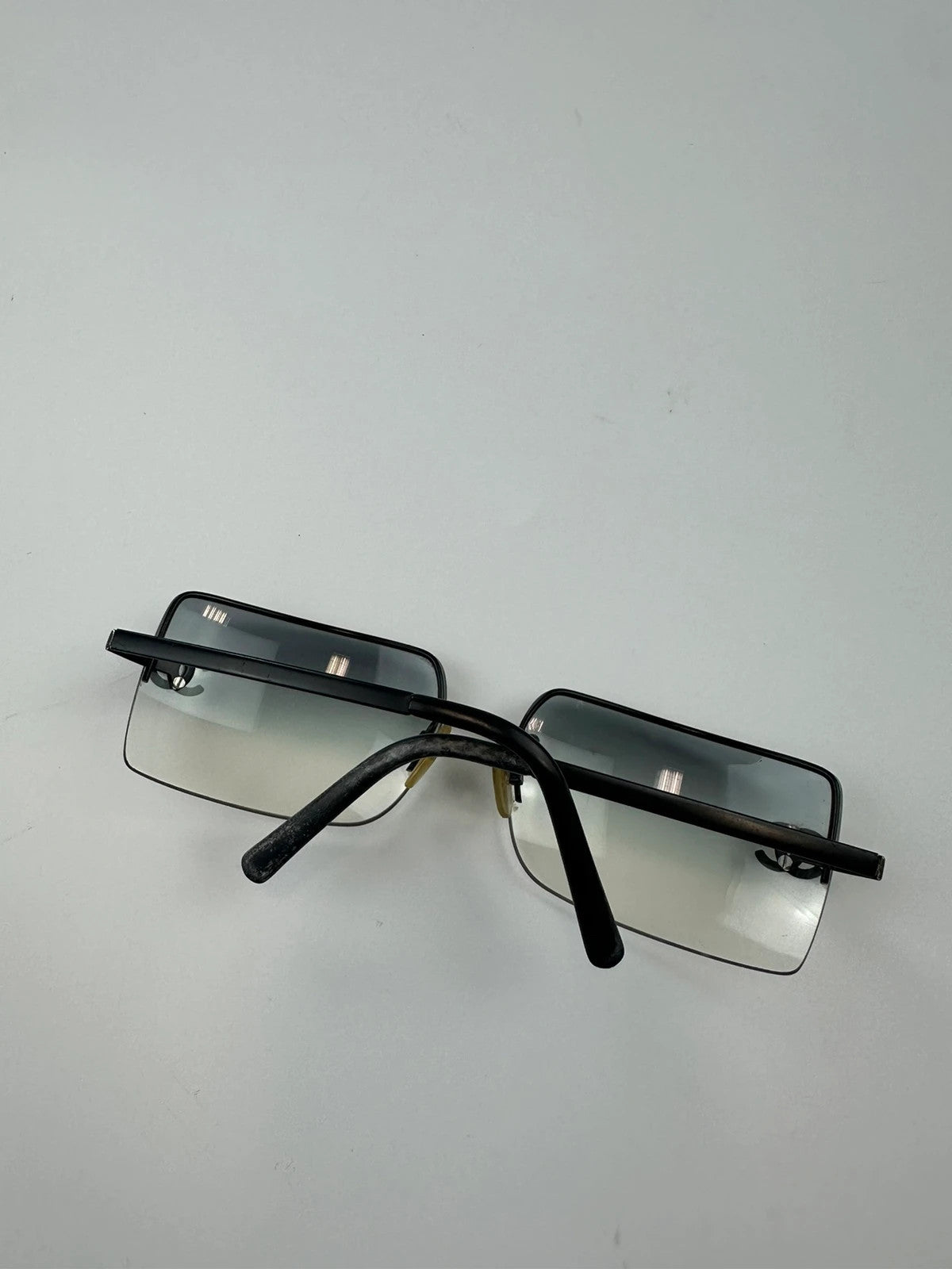Chanel black and blue rimless sunglasses with double CC logo and strass details.