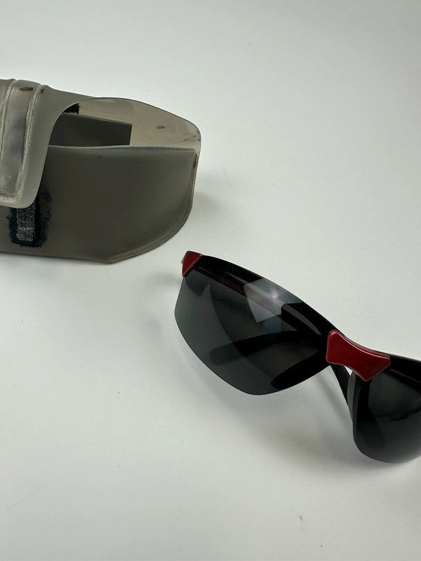 Prada Sport red and black sunglasses with titanium frame and black lenses.