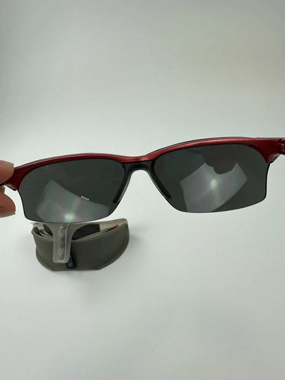 Prada Sport red and black sunglasses with titanium frame and black lenses.