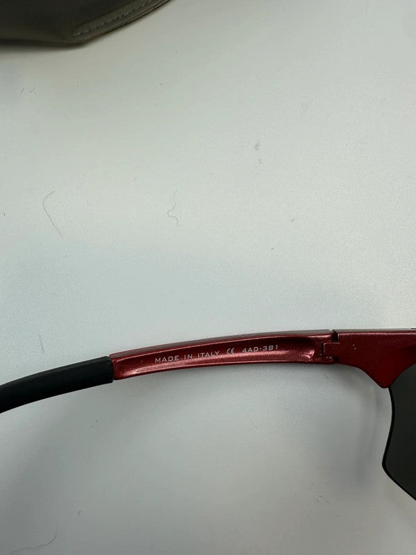 Prada Sport red and black sunglasses with titanium frame and black lenses.