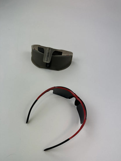 Prada Sport red and black sunglasses with titanium frame and black lenses.