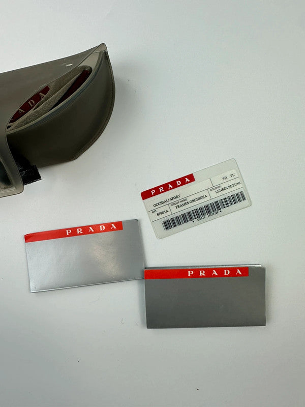 Prada Sport red and black sunglasses with titanium frame and black lenses.