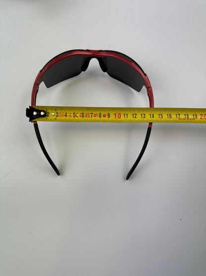 Prada Sport red and black sunglasses with titanium frame and black lenses.