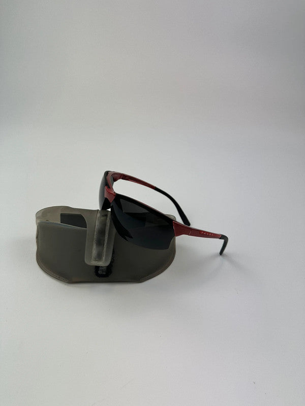 Prada Sport red and black sunglasses with titanium frame and black lenses.