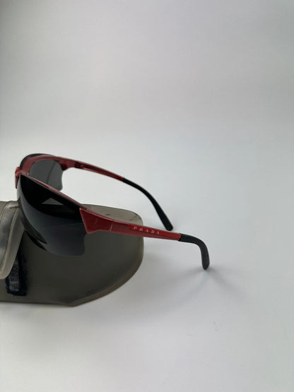 Prada Sport red and black sunglasses with titanium frame and black lenses.