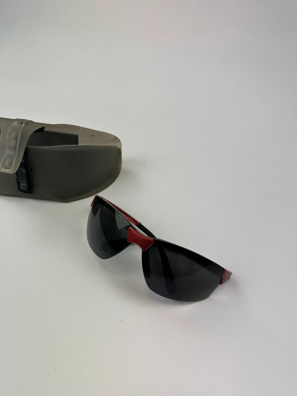 Prada Sport red and black sunglasses with titanium frame and black lenses.