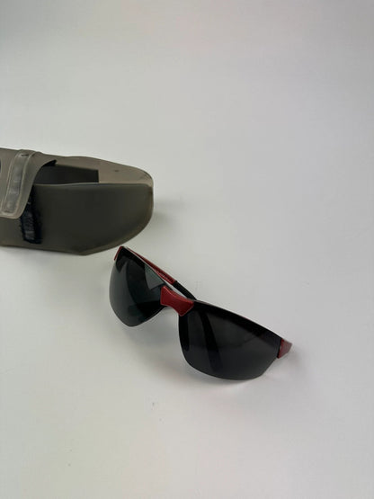 Prada Sport red and black sunglasses with titanium frame and black lenses.