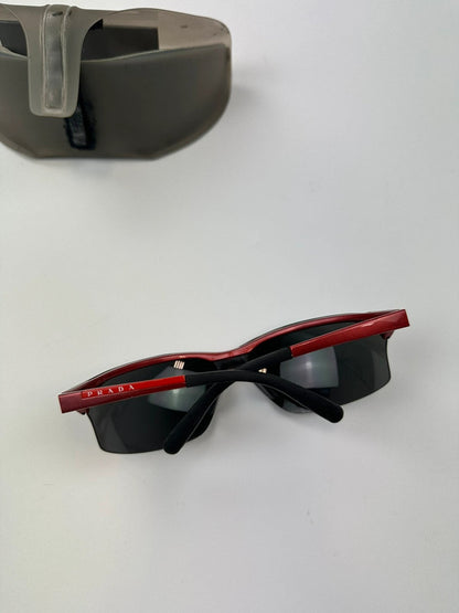 Prada Sport red and black sunglasses with titanium frame and black lenses.