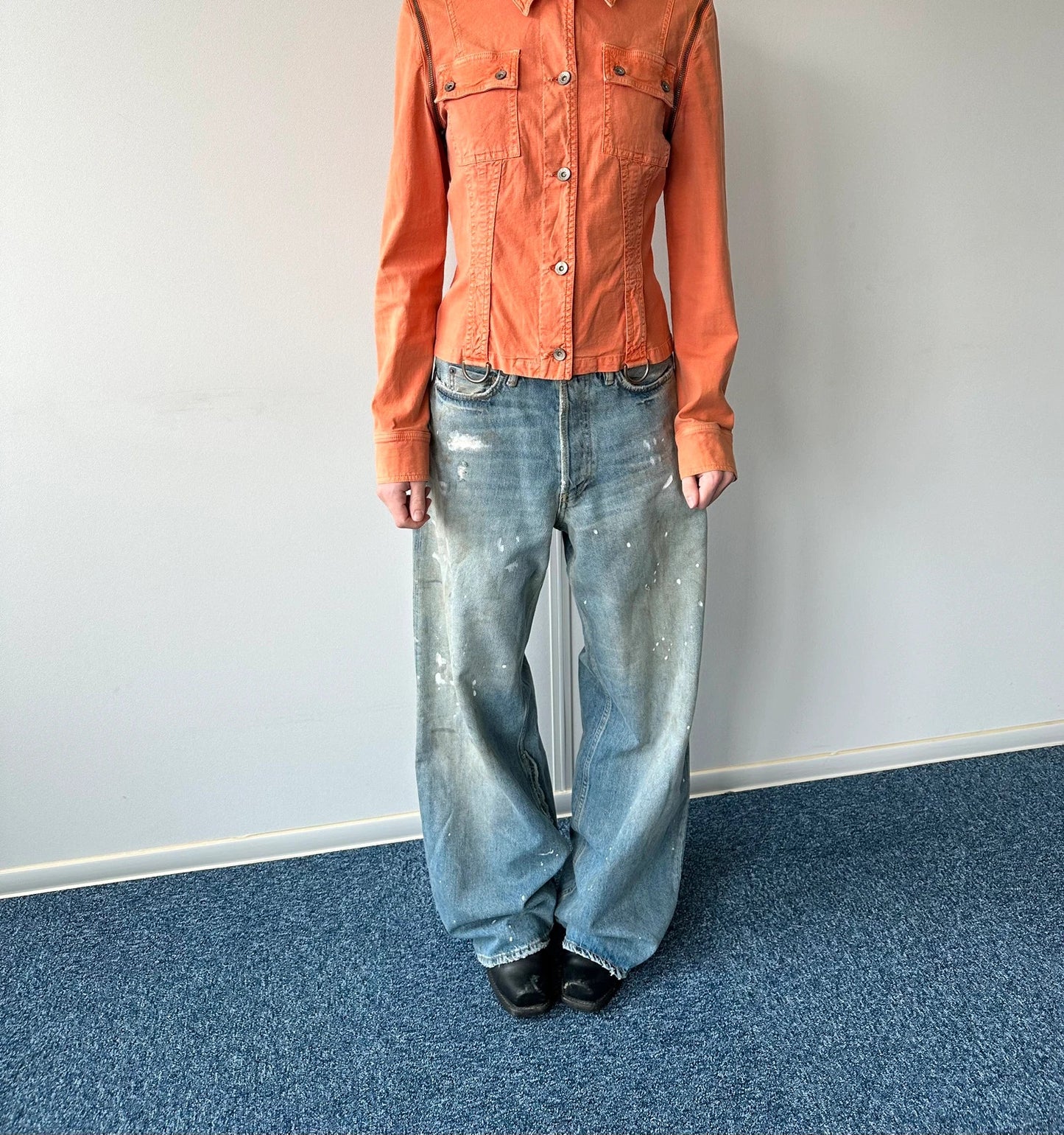 Acne Studios blue and white baggy jeans with intentional paint splatters and non-stretch denim.