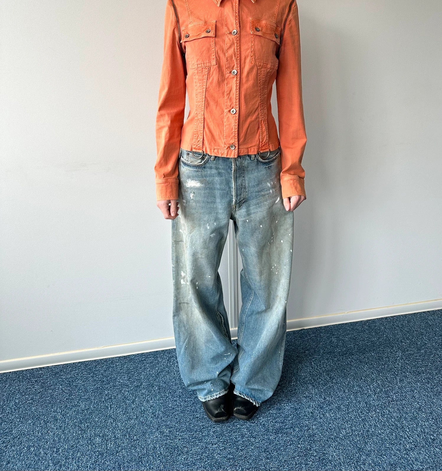 Acne Studios blue and white baggy jeans with intentional paint splatters and non-stretch denim.