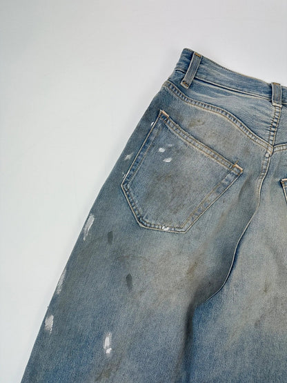 Acne Studios blue and white baggy jeans with intentional paint splatters and non-stretch denim.