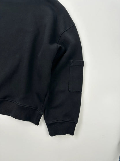 Prada black crop sweater with front pockets and logo detail, boxy fit.