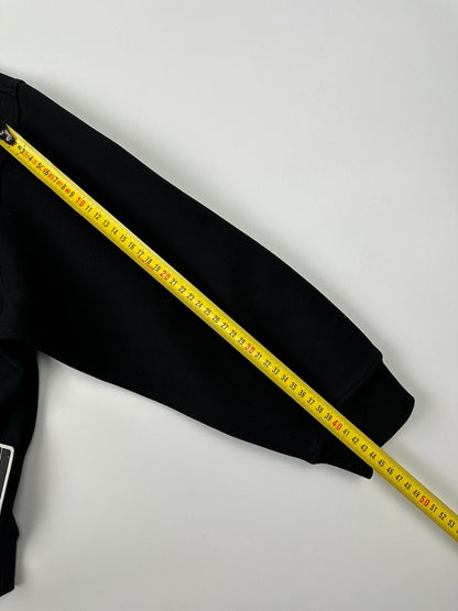 Prada black crop sweater with front pockets and logo detail, boxy fit.
