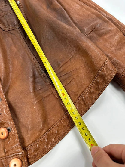 Marithé Francois Girbaud brown leather jacket with orange patches and logo details.