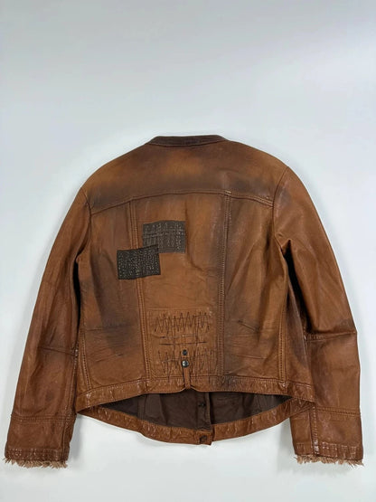 Marithé Francois Girbaud brown leather jacket with orange patches and logo details.