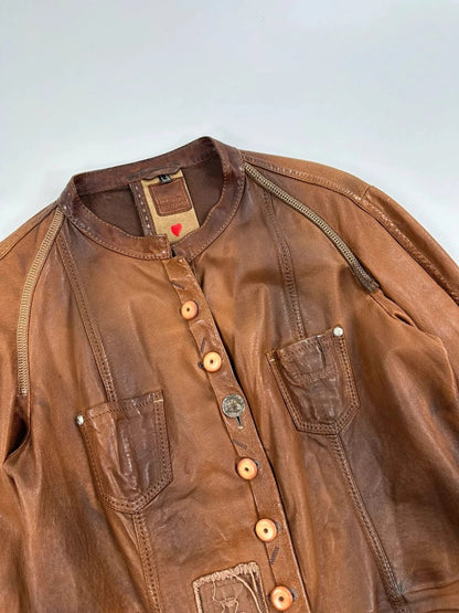 Marithé Francois Girbaud brown leather jacket with orange patches and logo details.