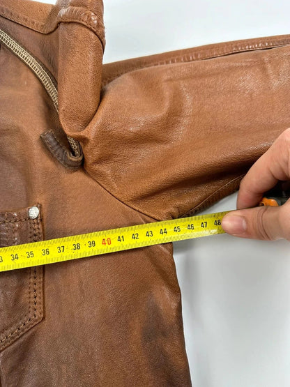 Marithé Francois Girbaud brown leather jacket with orange patches and logo details.