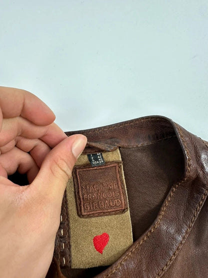 Marithé Francois Girbaud brown leather jacket with orange patches and logo details.